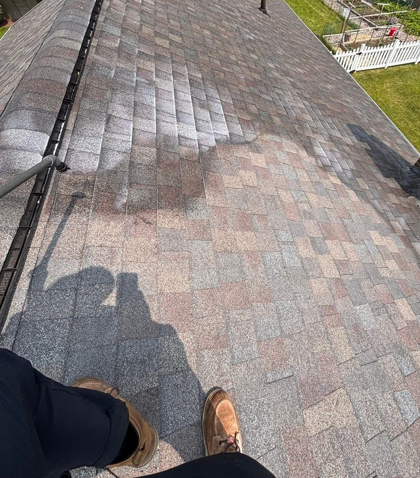 Roof rejuvenation treatment in progress showing treated and untreated sections